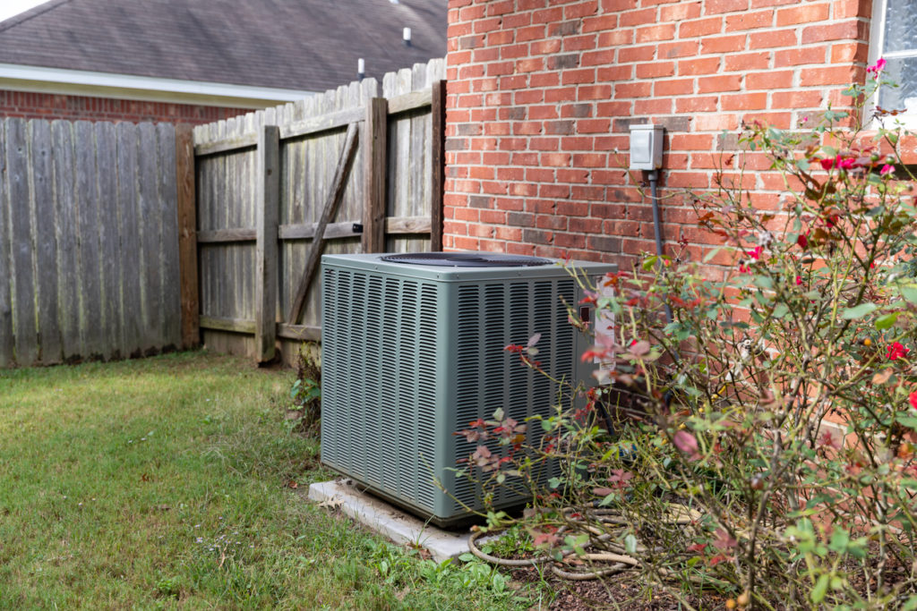 Air Conditioner system next to a home